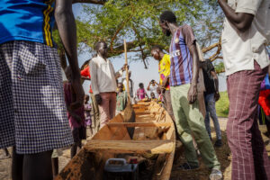 Community members looking at a canoe donated by MSF