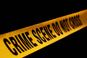 "CRIME SCENE DO NOT CROSS" on a black background.