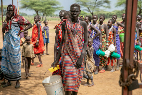 South Sudan. Woman entering food distribution site.